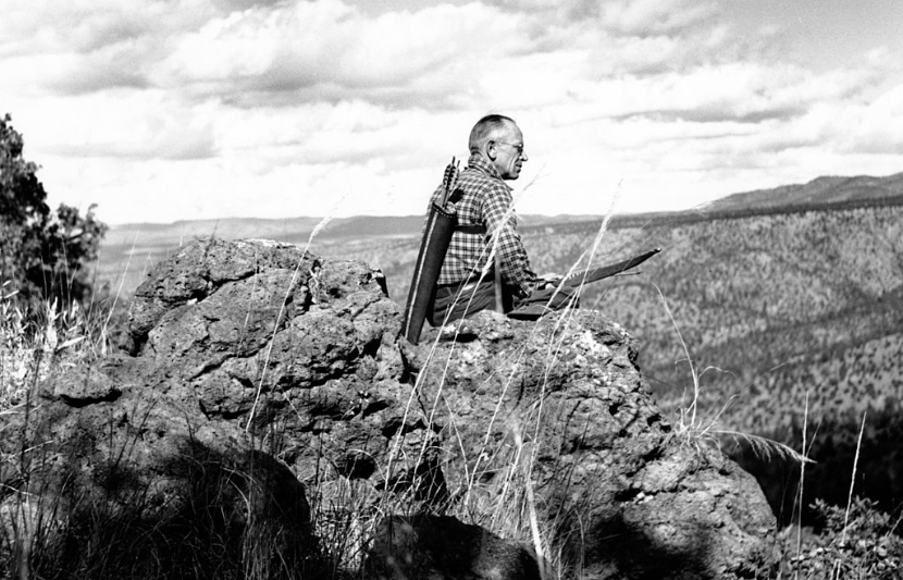 Aldo Leopold with bow above the Rio Gavilan in northern Mexico, 1938 